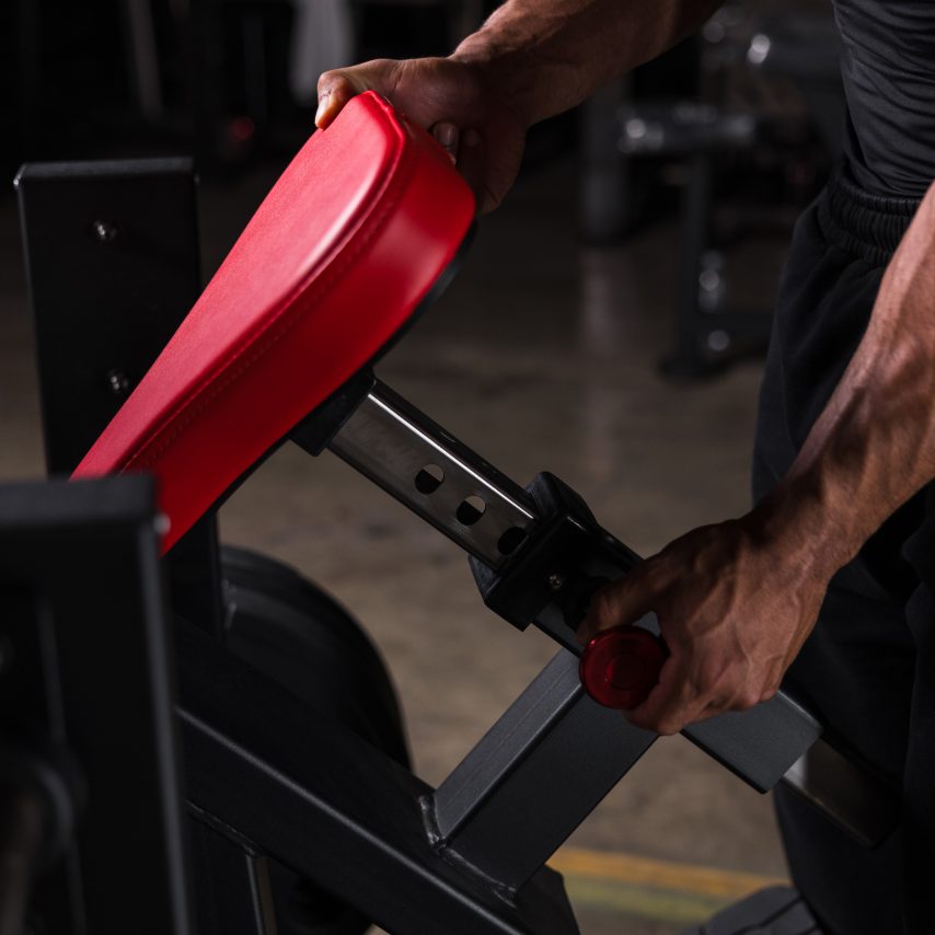 Hands setting the height of the PW625 seat on its notched post