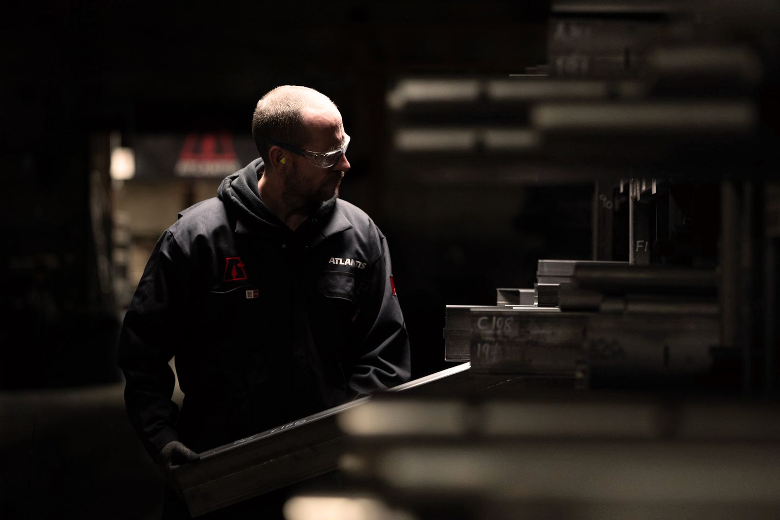 An Atlantis builder carries a length of steel tube through the Laval factory